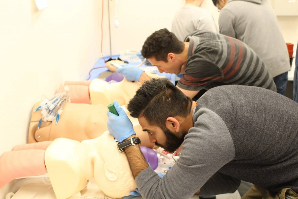 Saurin Patel and Benny Rossner practice intubation skills.