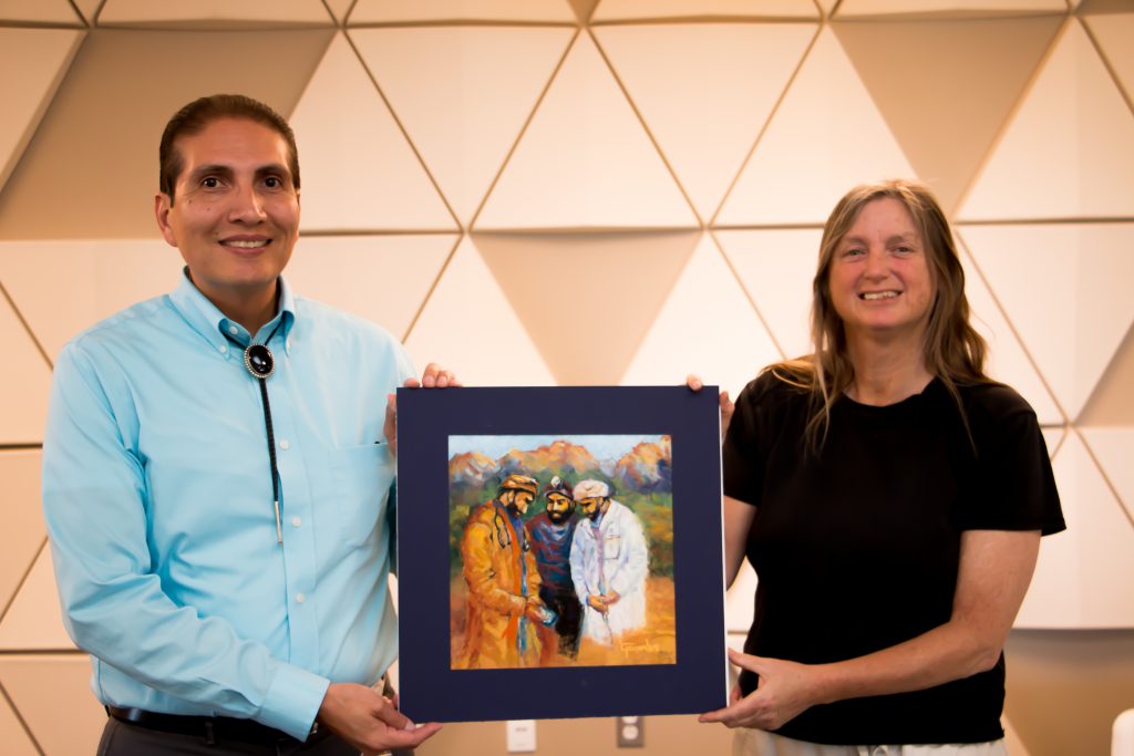 BCOM Chief of Staff Justin McHorse and artist Leslie Toombs with her pastel work titled The Doctors