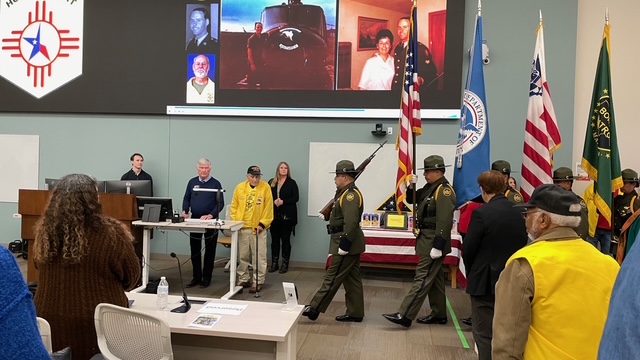 Military members walking out the flags at Honor Flight Reunion attendees at Burrell College in New Mexico