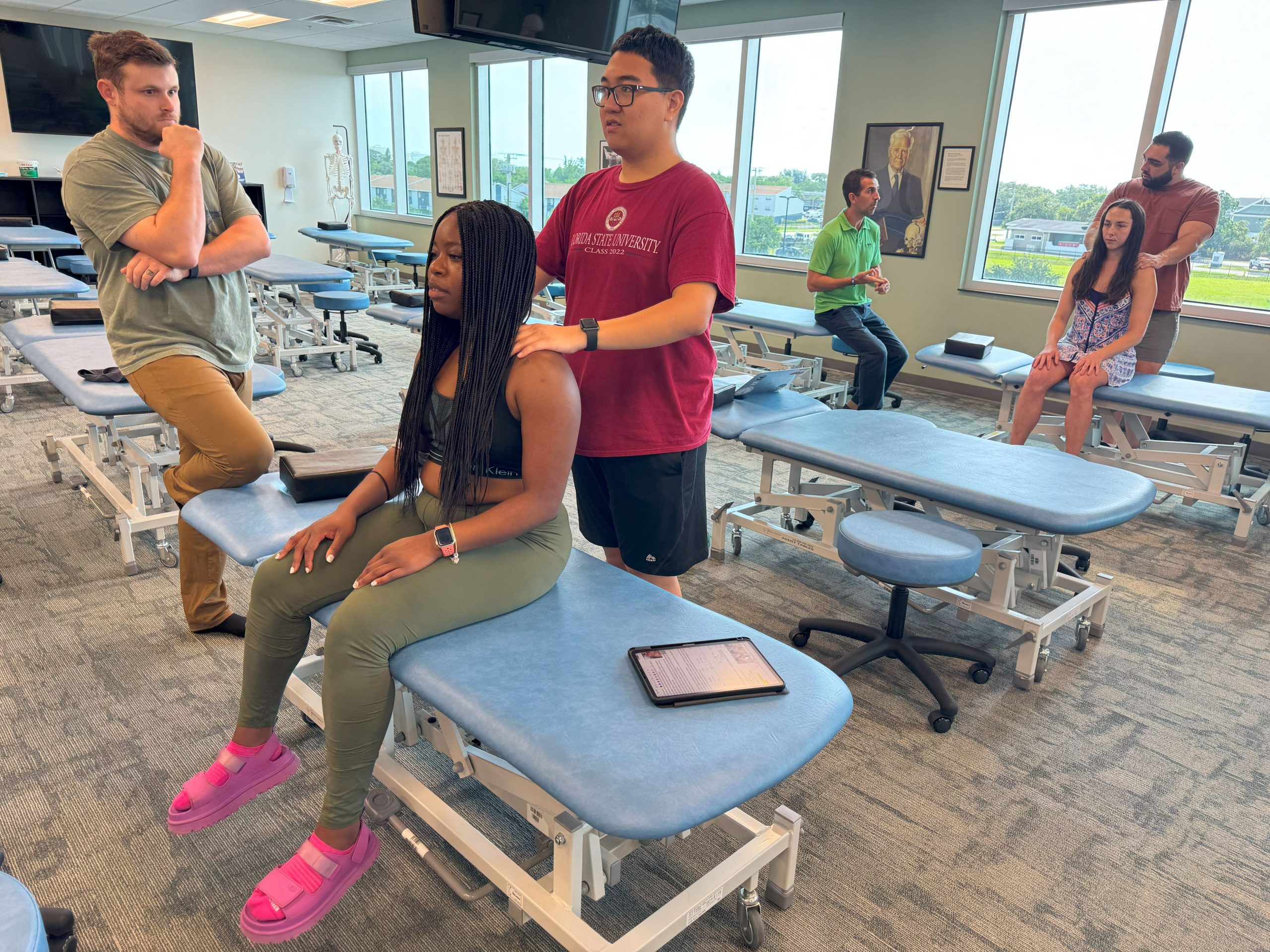 Student doctors at Burrell College practice osteopathic manipulative treatment in a clinical classroom setting.